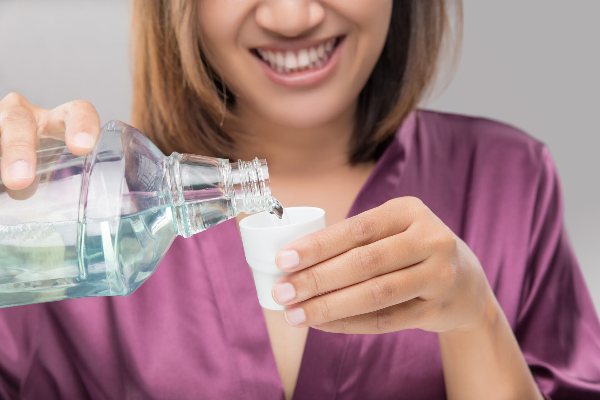 Woman Using Mouthwash After Brushing, Portrait  Hands Pouring Mouthwash Into Bottle Cap, Dental Health Concepts